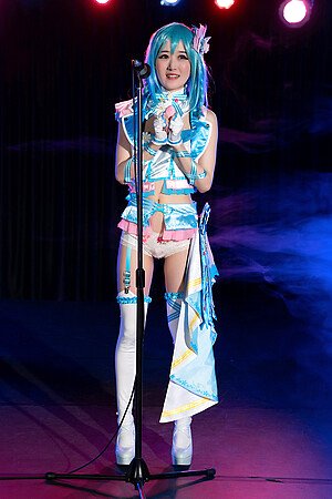 A slender Japanese Ria Kurumi sings on stage in white panties